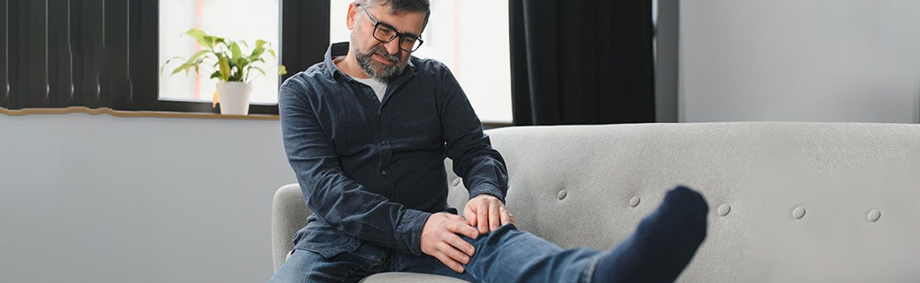 Person holding knee in pain, highlighting knee pain treatment at home