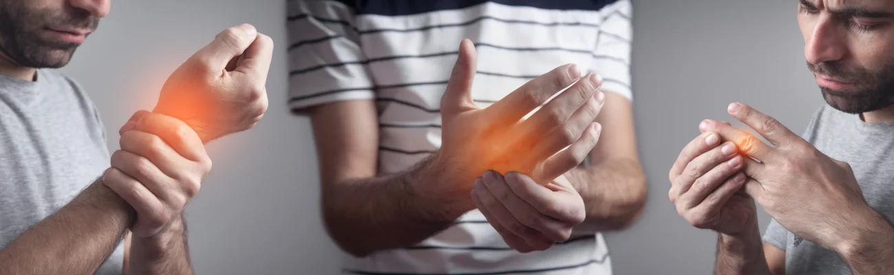 caucasian-man-with-pain-hand Man experiencing wrist and finger pain, indicating joint inflammation commonly treated with physiotherapy and hand therapy