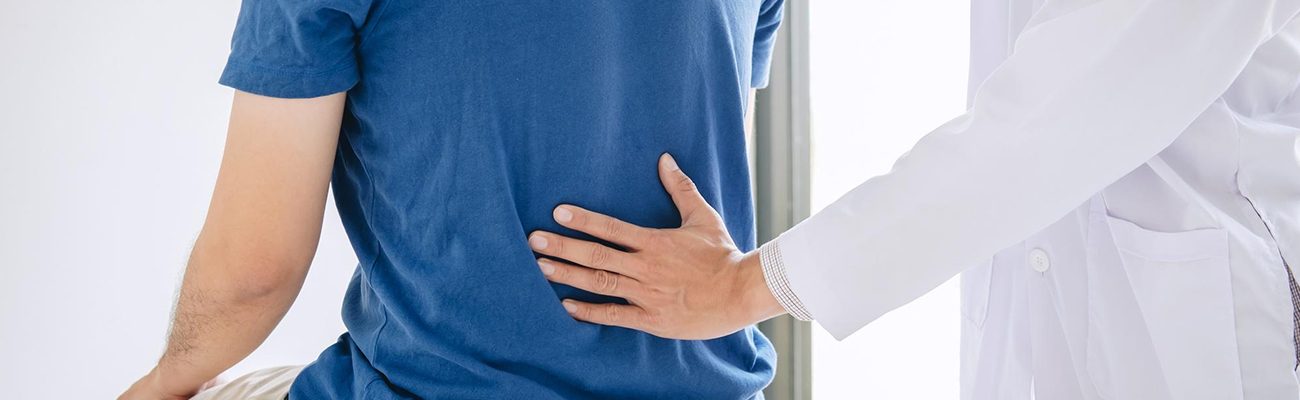 Physiotherapist in Gurgaon helping patient with lower back pain relief exercises.